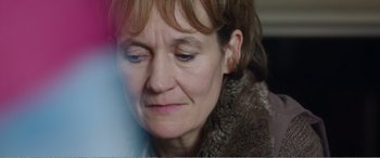 Movie still from “Adult Life Skills” (2016), directed by Rachel Tunnard – A person wearing a fur coat; Close Up shot, Over the shoulder angle
