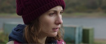 Movie still from “Adult Life Skills” (2016), directed by Rachel Tunnard – A person wearing a hat; Close Up shot, Over the shoulder angle