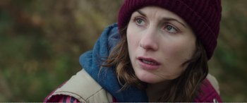Movie still from “Adult Life Skills” (2016), directed by Rachel Tunnard – A person wearing a jacket and a hat; Close Up shot, Over the shoulder angle
