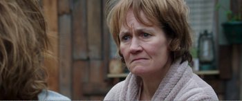 Movie still from “Adult Life Skills” (2016), directed by Rachel Tunnard – An older woman with a towel around her neck; Close Up shot, Over the shoulder angle