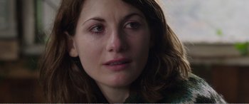 Movie still from “Adult Life Skills” (2016), directed by Rachel Tunnard – A woman's face with a sad look on her face; Close Up shot, Over the shoulder angle