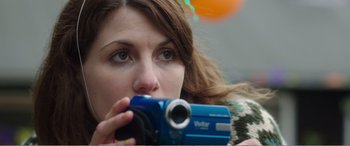 Movie still from “Adult Life Skills” (2016), directed by Rachel Tunnard – A person taking a picture with a video camera; Close Up shot, Over the shoulder angle