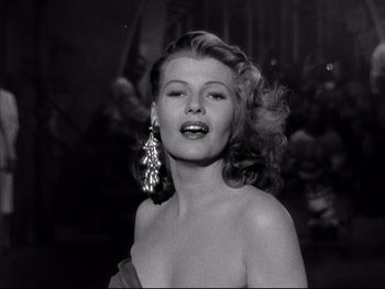 Movie still from “Affair in Trinidad” (1952), directed by Vincent Sherman – A black - and - white photo of a woman in a strapless dress; Close Up shot, Low angle