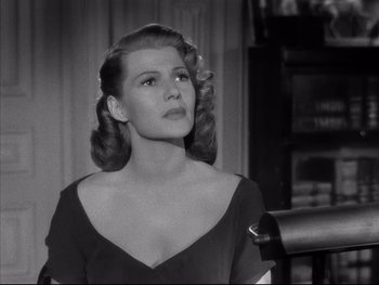 Movie still from “Affair in Trinidad” (1952), directed by Vincent Sherman – A black and white photo of a woman in a black dress; Close Up shot, Low angle