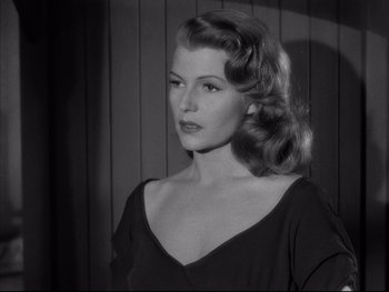 Movie still from “Affair in Trinidad” (1952), directed by Vincent Sherman – A black and white photo of a woman in a black dress; Close Up shot, Low angle