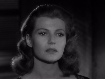 Movie still from “Affair in Trinidad” (1952), directed by Vincent Sherman – A black - and - white photo of a woman's face; Close Up shot, Low angle