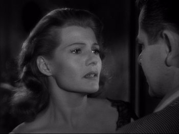 Movie still from “Affair in Trinidad” (1952), directed by Vincent Sherman – A black - and - white photo of a woman and a man; Close Up shot, Over the shoulder angle