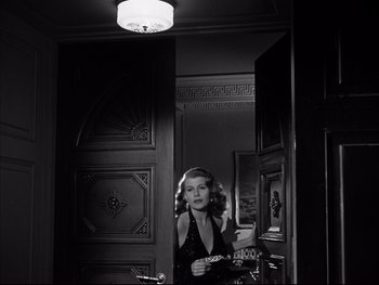 Movie still from “Affair in Trinidad” (1952), directed by Vincent Sherman – A black and white photo of a woman in a mirror; Medium shot, Low angle