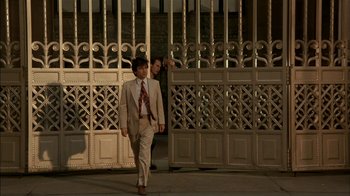 Movie still from “After Hours” (1985), directed by Martin Scorsese – Two men in suits and ties walking down a street; Wide shot, Low angle