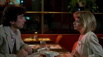 Movie still from “After Hours” (1985), directed by Martin Scorsese – A man and a woman sitting at a table in a restaurant; Medium shot, Over the shoulder angle