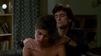 Movie still from “After Hours” (1985), directed by Martin Scorsese – A young man and a young woman embracing in a room; Close Up shot, Over the shoulder angle