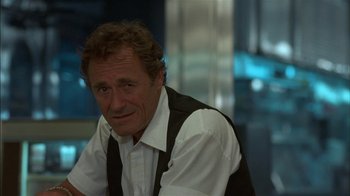 Movie still from “After Hours” (1985), directed by Martin Scorsese – A person wearing a white shirt and a black vest; Close Up shot, Over the shoulder angle
