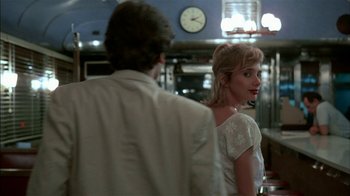 Movie still from “After Hours” (1985), directed by Martin Scorsese – A man and a woman standing next to each other; Medium shot, Over the shoulder angle