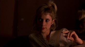 Movie still from “After Hours” (1985), directed by Martin Scorsese – A woman is holding a remote control in her hand; Close Up shot, Over the shoulder angle