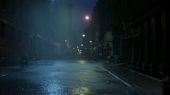 Movie still from “After Hours” (1985), directed by Martin Scorsese – A dark street with lights and buildings in the background; Extreme Wide shot, High angle