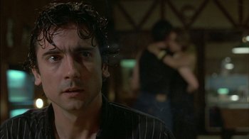 Movie still from “After Hours” (1985), directed by Martin Scorsese – A person wearing a black shirt; Close Up shot, Over the shoulder angle