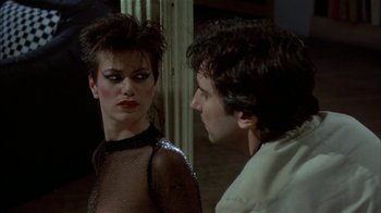 Movie still from “After Hours” (1985), directed by Martin Scorsese – A man and a woman looking at one another in front of a mirror; Close Up shot, Over the shoulder angle
