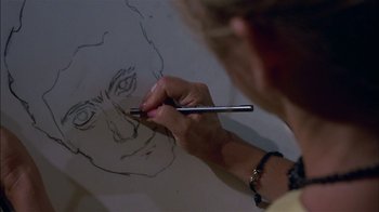 Movie still from “After Hours” (1985), directed by Martin Scorsese – A person drawing a picture with a pencil; Extreme Close Up shot, High angle