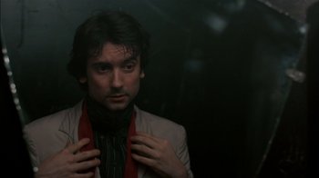 Movie still from “After Hours” (1985), directed by Martin Scorsese – A man in a suit and tie holding his tie; Close Up shot, Low angle