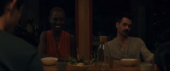 Movie still from “After Yang” (2021), directed by Kogonada – Two people sitting at a table with a bowl of fruit; Medium shot, Over the shoulder angle