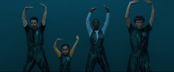 Movie still from “After Yang” (2021), directed by Kogonada – Two young people are standing in the dark; Extreme Wide shot, High angle