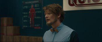 Movie still from “After Yang” (2021), directed by Kogonada – A man wearing a bow tie and a blue shirt; Close Up shot, Over the shoulder angle
