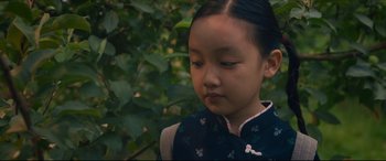 Movie still from “After Yang” (2021), directed by Kogonada – A little girl wearing a blue and white dress; Close Up shot, High angle
