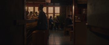 Movie still from “After Yang” (2021), directed by Kogonada – People are sitting at tables in a restaurant; Wide shot, Over the shoulder angle