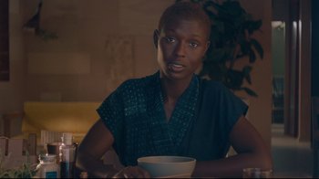 Movie still from “After Yang” (2021), directed by Kogonada – A woman sitting at a table with a bowl in front of her; Close Up shot, Over the shoulder angle