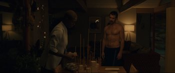 Movie still from “After Yang” (2021), directed by Kogonada – A man standing next to another man in front of a table; Medium shot, Over the shoulder angle