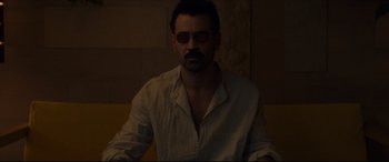 Movie still from “After Yang” (2021), directed by Kogonada – A man wearing a white shirt and a pair of sunglasses; Close Up shot, Low angle
