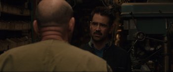 Movie still from “After Yang” (2021), directed by Kogonada – A man looking at another man in a room; Close Up shot, Over the shoulder angle