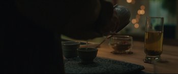 Movie still from “After Yang” (2021), directed by Kogonada – A person pouring a cup of tea into a bowl; Extreme Close Up shot, Low angle