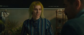 Movie still from “After Yang” (2021), directed by Kogonada – A woman with yellow hair standing in a room; Medium shot, Over the shoulder angle