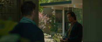 Movie still from “After Yang” (2021), directed by Kogonada – Two men standing in front of a house; Medium shot, Over the shoulder angle