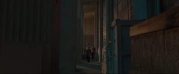 Movie still from “After Yang” (2021), directed by Kogonada – Two people are walking down the steps of a building; Extreme Wide shot, Low angle