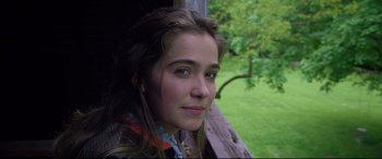 Movie still from “After Yang” (2021), directed by Kogonada – A young woman is sitting on a bench outside; Close Up shot, Over the shoulder angle