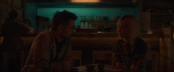 Movie still from “After Yang” (2021), directed by Kogonada – A man and a woman sitting at a dinner table; Medium shot, Over the shoulder angle