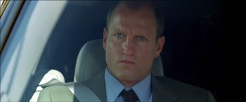 Movie still from “After the Sunset” (2004), directed by Brett Ratner – A person wearing a suit and tie; Close Up shot, Low angle