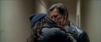 Movie still from “After the Sunset” (2004), directed by Brett Ratner – A man and a woman are kissing in a room; Close Up shot, Over the shoulder angle
