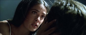 Movie still from “After the Sunset” (2004), directed by Brett Ratner – A person holding something in their hand; Extreme Close Up shot, Over the shoulder angle