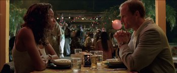 Movie still from “After the Sunset” (2004), directed by Brett Ratner – A man and a woman sitting at a dinner table; Close Up shot, Over the shoulder angle