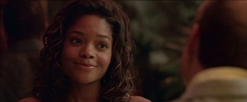 Movie still from “After the Sunset” (2004), directed by Brett Ratner – A person with curly hair smiling; Close Up shot, Over the shoulder angle