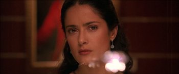 Movie still from “After the Sunset” (2004), directed by Brett Ratner – A person wearing a necklace and earrings; Close Up shot, Over the shoulder angle