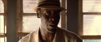 Movie still from “After the Sunset” (2004), directed by Brett Ratner – A person wearing a hat; Close Up shot, Low angle