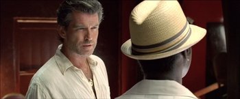 Movie still from “After the Sunset” (2004), directed by Brett Ratner – A man wearing a white shirt and a straw hat; Close Up shot, Over the shoulder angle