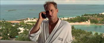 Movie still from “After the Sunset” (2004), directed by Brett Ratner – A man talking on a cell phone while wearing a robe; Close Up shot, Low angle