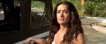 Movie still from “After the Sunset” (2004), directed by Brett Ratner – A woman sitting in the driver's seat of a car; Close Up shot, Low angle
