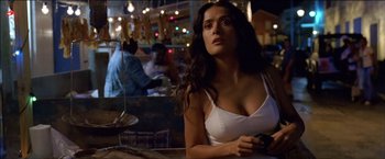 Movie still from “After the Sunset” (2004), directed by Brett Ratner – A woman sitting at a table in a restaurant; Close Up shot, Low angle