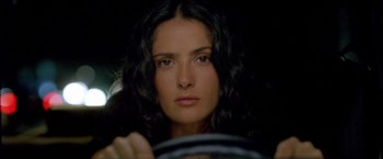 Movie still from “After the Sunset” (2004), directed by Brett Ratner – A woman sitting behind a steering wheel of a car; Close Up shot, High angle